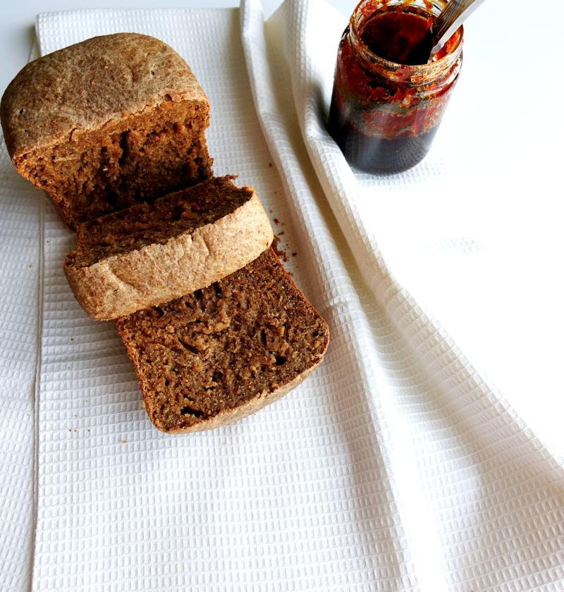 honey wheat bread with an open can of buckwheat honey